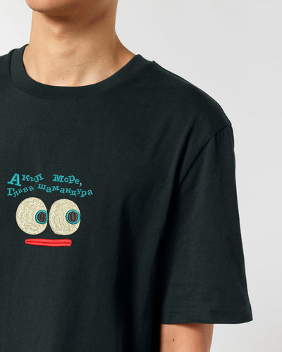 Black t-shirt with a graphic design on a plain background